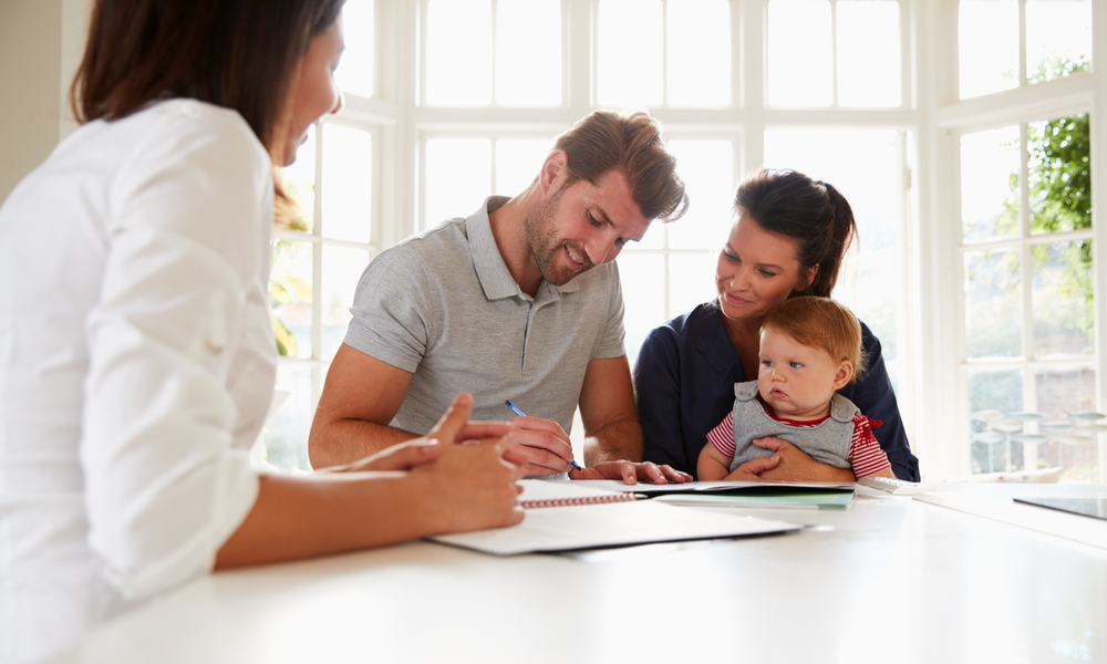 parenst filling out paperwork with baby