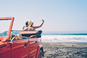 couple taking selfies on the beach