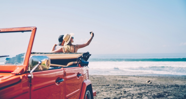 couple taking selfies on the beach