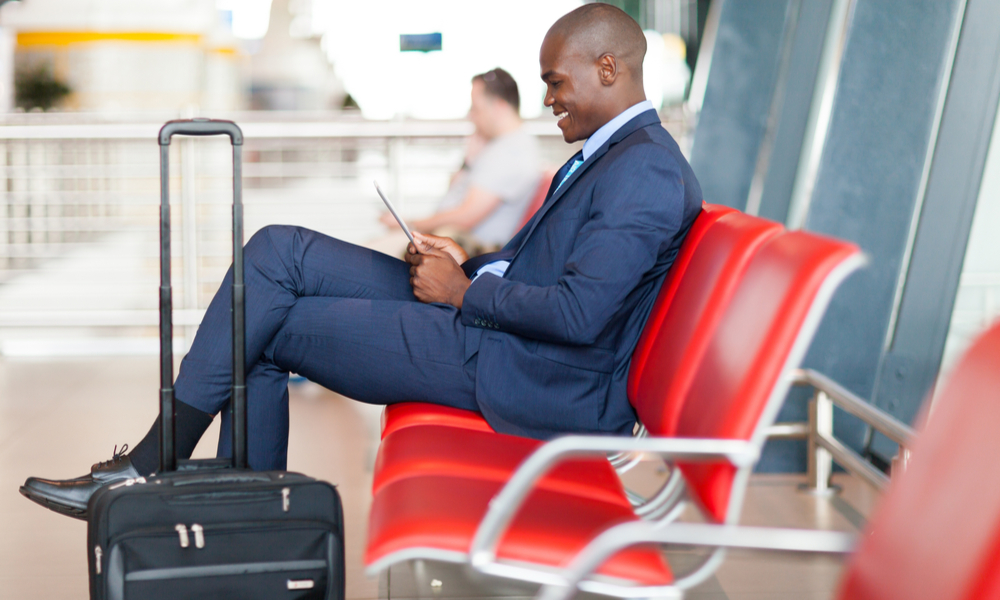 modern african businessman using tablet computer at airport