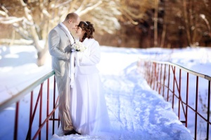 7 Winter Wedding Ideas That Will Help You Find the Perfect Spot to Say "I Do": bride and groom in the winter woods