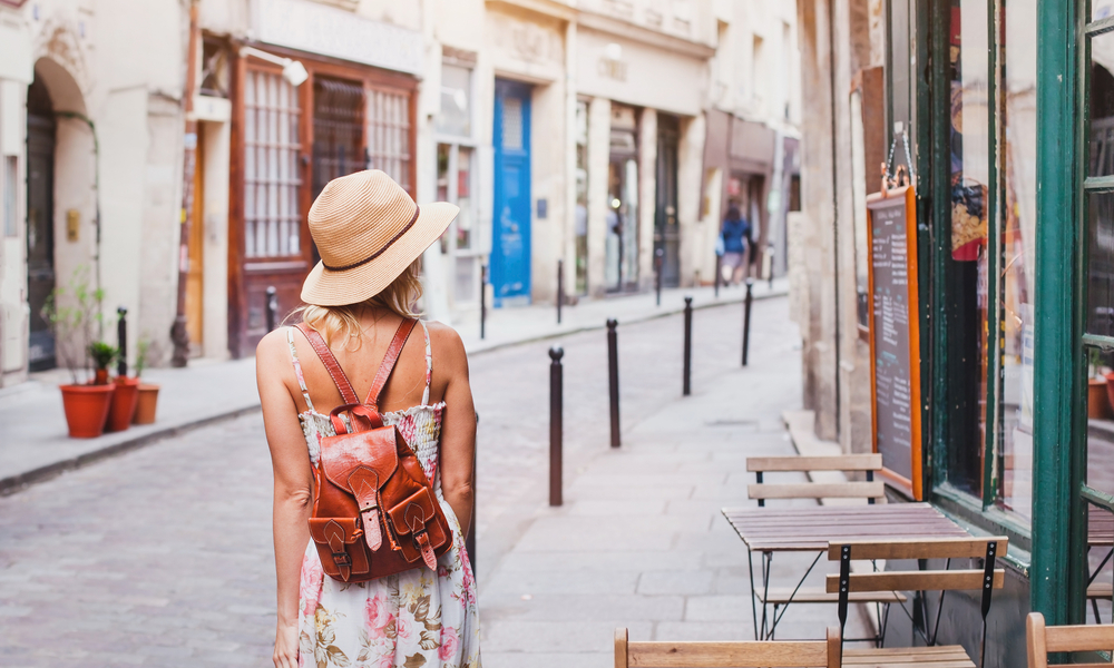 how to stay safe abroad: woman tourist walking on the street in Europe