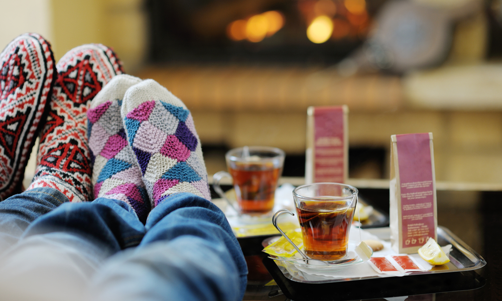 happy Young romantic couple and relaxing sofa in front of fireplace at winter season