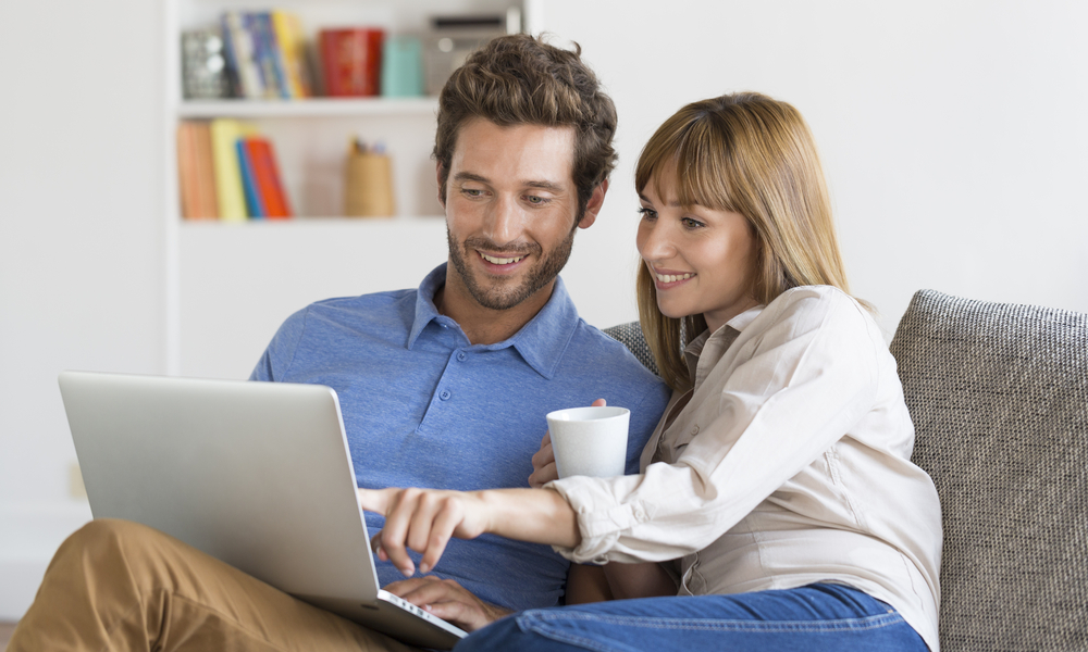 Young couple surfing on internet with laptop