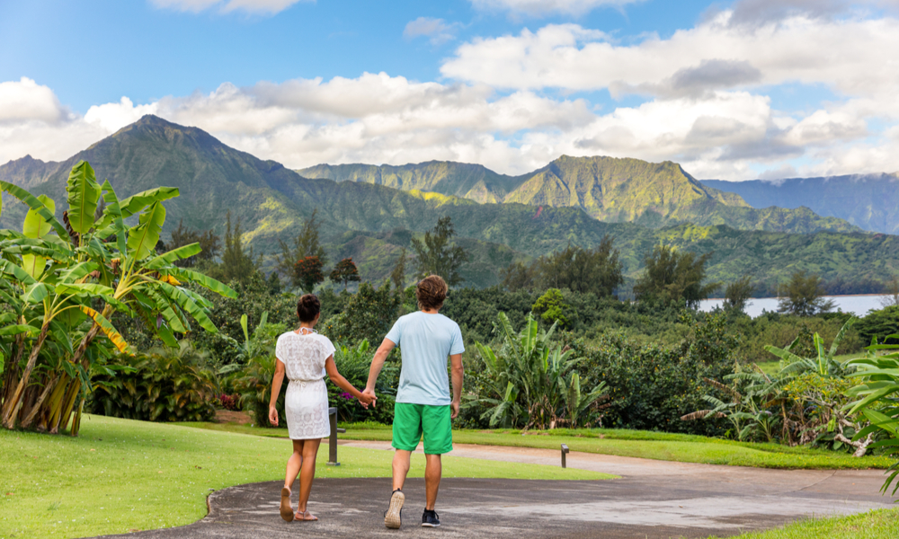  The Best Winter Getaways Where You Can Forget the Cold: Couple tourists walking on Hawaii vacation.