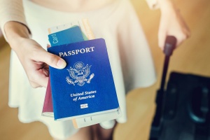 How to Avoid Common Visa Mistakes When Flying Internationally: Closeup of girl holding passports and boarding pass