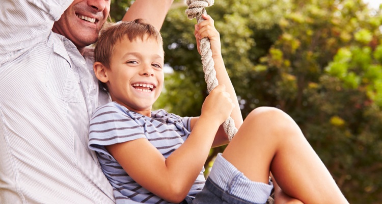 Best Free Things You Can Do in Denver with Kids: Father swinging with son at a playground