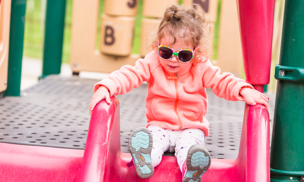  Best Free Things You Can Do in Denver with Kids: Toddler playing at the playground in urban park.