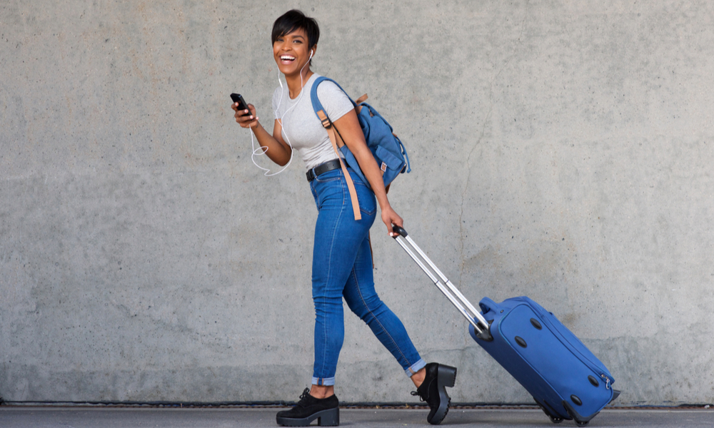 how to travel cheap: woman with light luggage