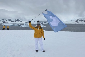 how to get to antarctica: waving the antarctica flag on the continent