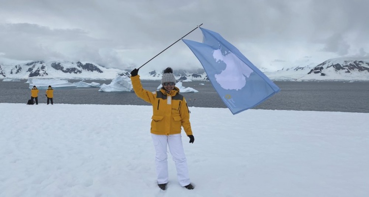 how to get to antarctica: waving the antarctica flag on the continent