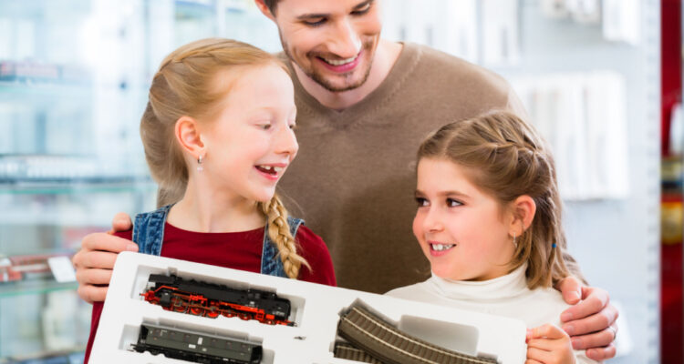 family playing with train playset