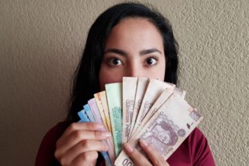 Girl with Mexican pesos