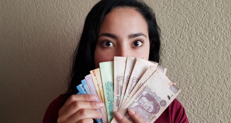 Girl with Mexican pesos