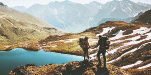 Couple exploring a mountain lake