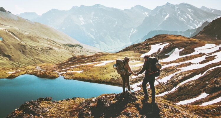 Couple exploring a mountain lake