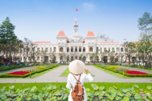 Woman in front of Ho Chi Minh City Palace