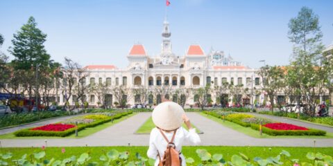 Woman in front of Ho Chi Minh City Palace