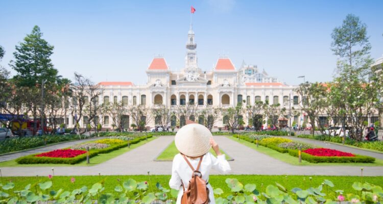 Woman in front of Ho Chi Minh City Palace