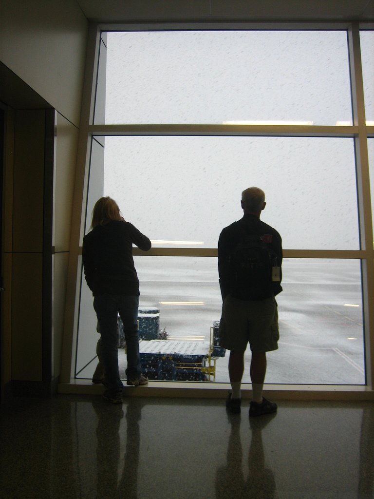 Travelers inspect the weather outside of DFW (Flickr: adactio)