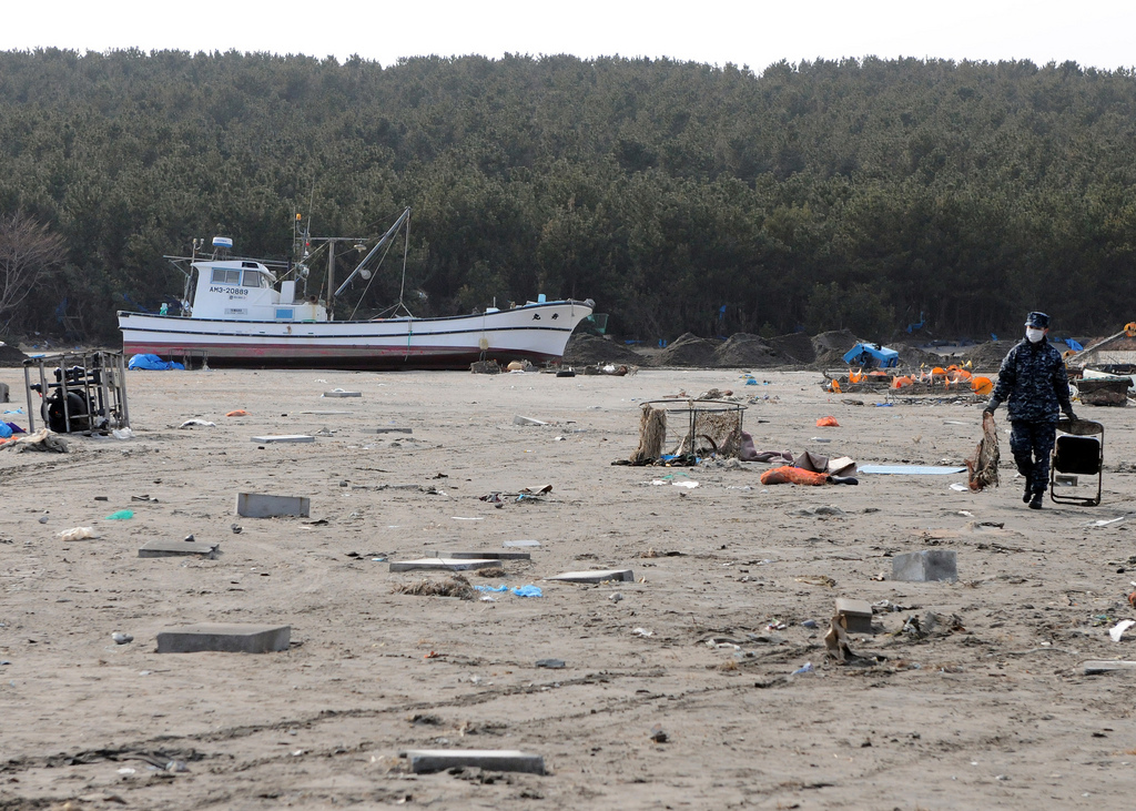 A member of the US Navy assists in the clean-up at the Misawa 
Fishing Port (Flicr: Official U.S. Navy Imagery) 