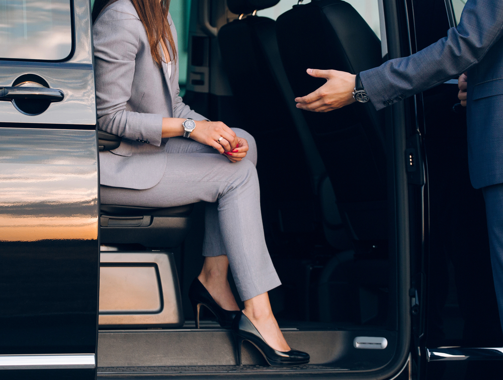 woman in shuttle bus being helped out