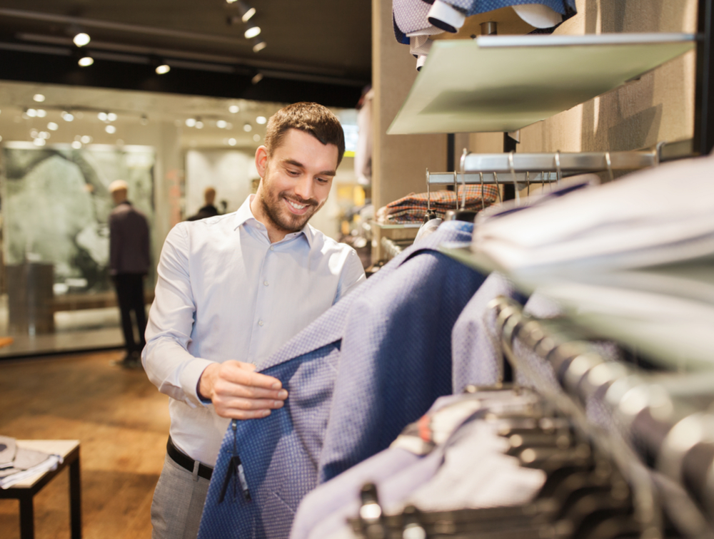 a man shopping in clothing store