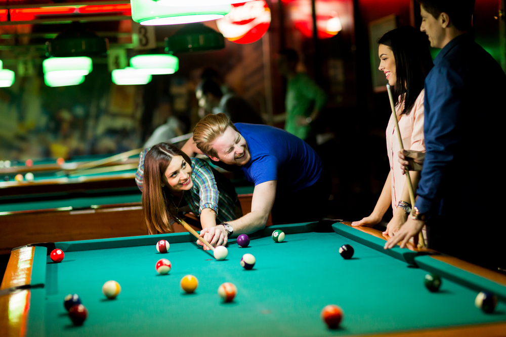 Young couple playing pool