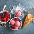 Raspberry ice cream in white bowl overhead shot