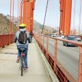 man cycling on golden gate