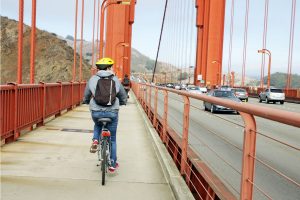 man cycling on golden gate