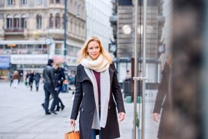 Woman window shopping in center of the city. Winter