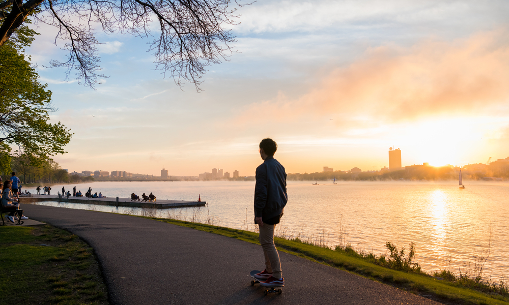 The man is skating during the sunset at Charles River Esplanade in Boston, USA