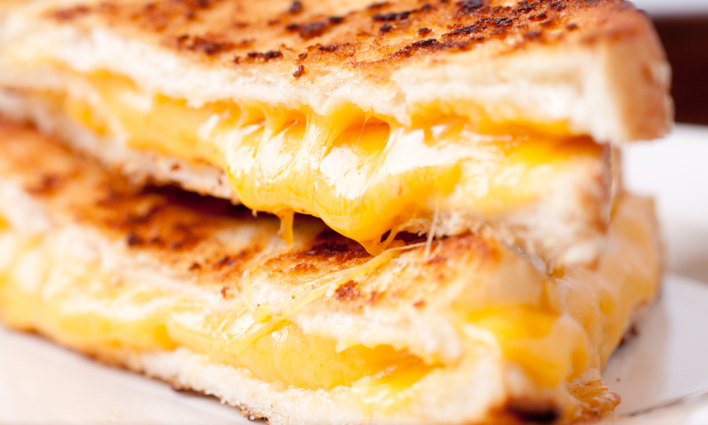 gooey delicious grilled cheese sandwiches cut in half