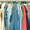 Vintage second hand clothes hanging on shop rack at weekly flea market