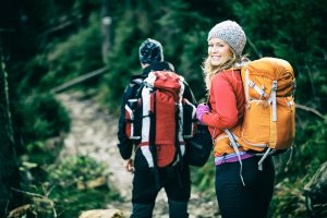 Man and woman hikers trekking in mountains