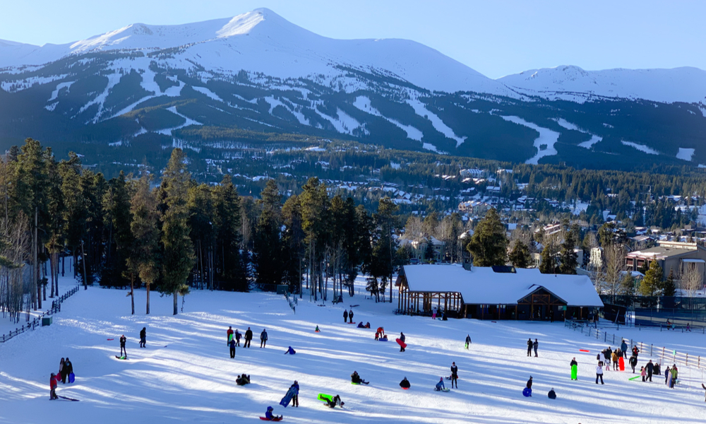  Exciting & adventurous things to do in denver: Kids sledding at Carter Park on a snowy hill in Breckenridge, Colorado.